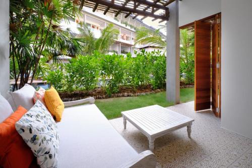 a living room with a couch and a coffee table at laïla, Seychelles, a Tribute Portfolio Resort in Mahe