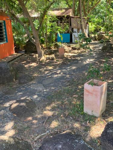 a cement block sitting on the ground next to a house at Les Manguiers in Deshaies