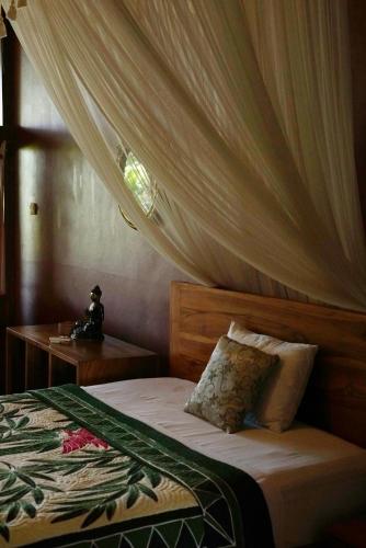 Ένα ή περισσότερα κρεβάτια σε δωμάτιο στο Sunrise Villa Ubud