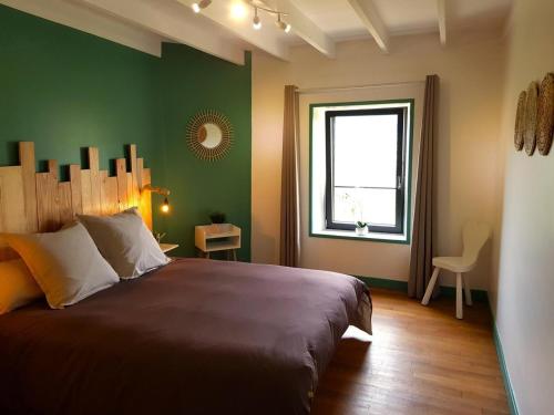 LaprugneにあるGîte Laprugne, 4 pièces, 6 personnes - FR-1-489-458の緑の壁のベッドルーム1室(大型ベッド1台付)