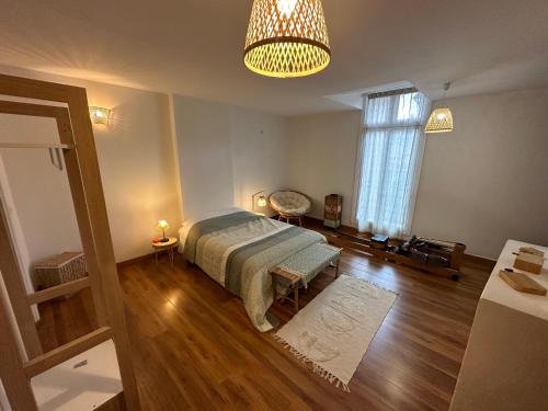 a bedroom with a bed and a large window at Historical center 3 st house, garage & tropeziene in Pézenas