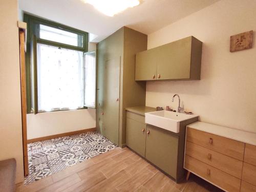 a kitchen with a sink and a window at Historical center 3 st house, garage & tropeziene in Pézenas