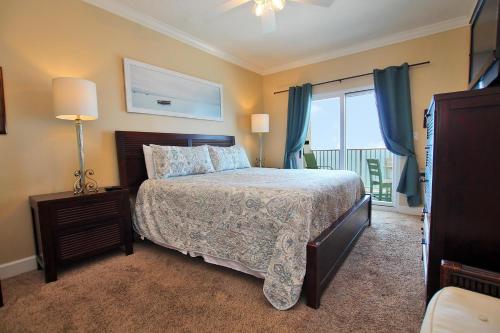 a bedroom with a bed and a large window at Seawind 1205 in Gulf Shores