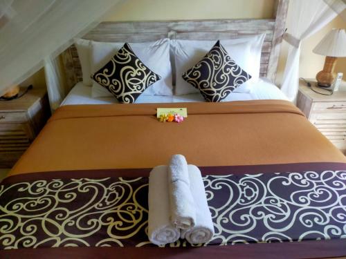 Una cama o camas en una habitación de Alam Pracetha Bali Ubud