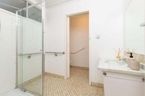 a bathroom with a shower and a sink at Trade Winds in Elizabeth Beach