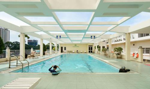 a pool in a building with people sitting in it at Victory Sai Gon Hotel in Ho Chi Minh City