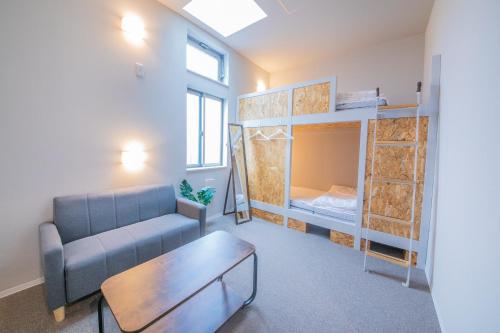 a living room with a couch and bunk beds at KIZUNA HOTEL Gojo Kiyomizu-dera Kamogawa in Kyoto