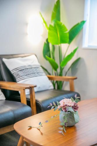a living room with a coffee table and a couch at KIZUNA HOTEL Gojo Kiyomizu-dera Kamogawa in Kyoto