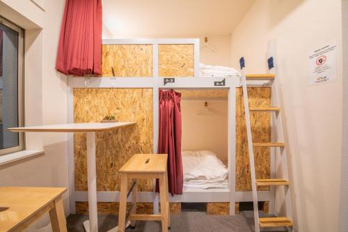 a room with a bunk bed in a tiny house at KIZUNA HOTEL Gojo Kiyomizu-dera Kamogawa in Kyoto