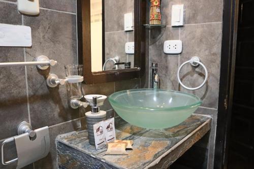 a bathroom with a green bowl sink on a counter at Cusco Bed and Breakfast in Cusco