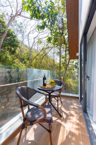 a patio with a table and chairs on a balcony at Cosa villages in Vung Tau