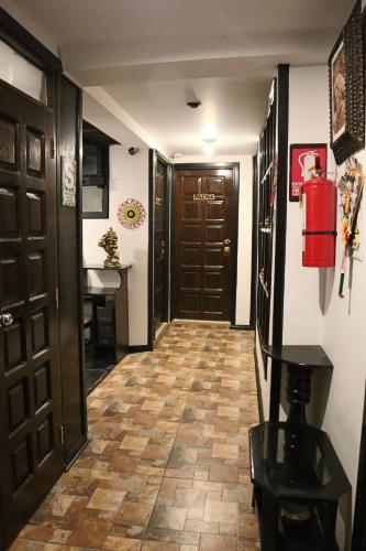 a hallway with a door and a tile floor at Cusco Bed and Breakfast in Cusco