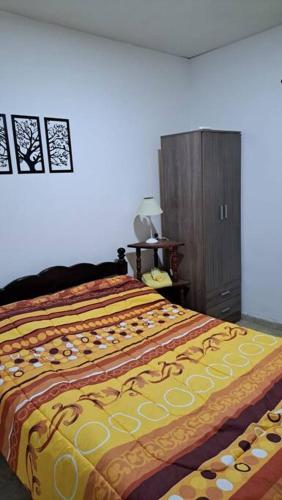 a bedroom with a bed and a wooden cabinet at centrico pb "A" in Resistencia