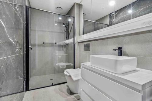 a bathroom with a toilet and a sink and a shower at Home*walking Chadstone shopping centre in Chadstone
