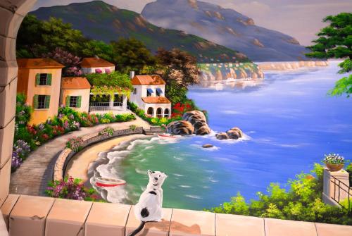 a painting of a white dog sitting on a wall at Tasme Hotel in Da Lat
