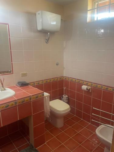 a bathroom with a toilet and a sink at The Victory Villa in Parrot Hall