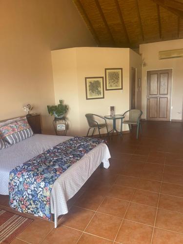 a bedroom with a bed and a table and chairs at The Victory Villa in Parrot Hall
