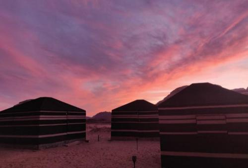 three large domes in the desert with a sunset at joy of life in Wadi Rum