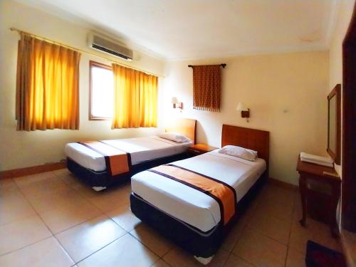 Postel nebo postele na pokoji v ubytování Horison Resort Pondok Layung Anyer