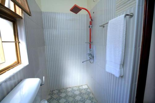 a bathroom with a shower and a toilet and a sink at DISCOVERY COURTS HOTEL in Entebbe