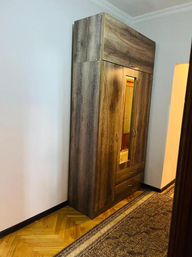 a wooden door in the corner of a room at holiday apartment in Batumi