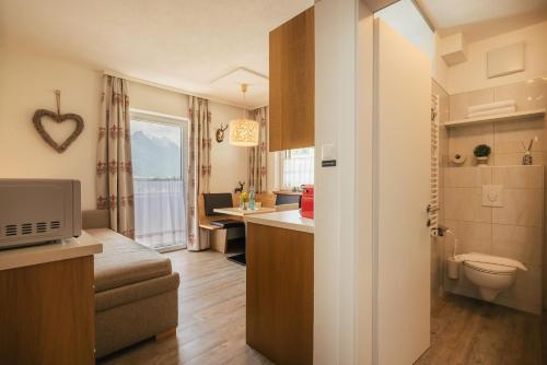 a small room with a kitchen and a bathroom at Apartments Morandell in Fulpmes