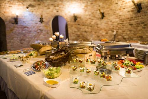 a buffet line with food on a table at Vinné sklepy Skalák in Skalka