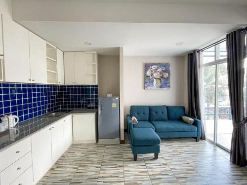 a living room with a blue couch in a kitchen at ANANTAYA CHIANGMAI BOUTIQUE HOTEL in Chiang Mai