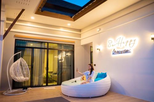 a woman sitting in a white tub in a room at so happy pool villa hua hin in Ban Bo Fai