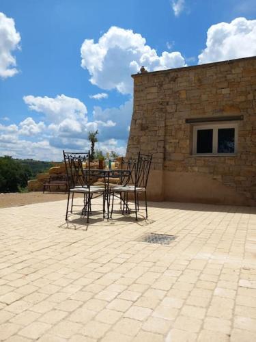 une table et des chaises assises sur une terrasse dans l'établissement Chez Christophe Valensole, à Valensole