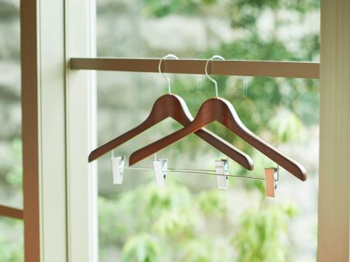 a wooden hanger in front of a window at Sotetsu Fresa Inn Kitahama in Osaka