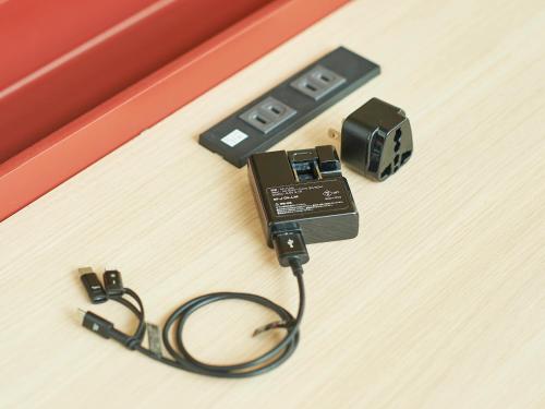 a electronic device on a table with a charger at Sotetsu Fresa Inn Kitahama in Osaka
