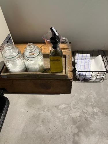 a wooden tray with jars and a bottle of oil at １日１組様限定「レジデンス」 in Nagano