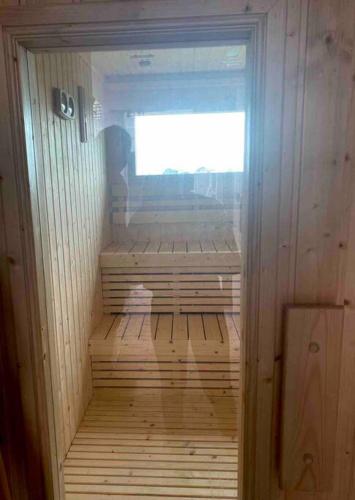 an empty wooden sauna with a window in it at Lovely condo with swimming pool. in Bang Sare