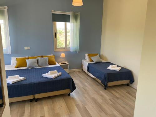 a room with two beds and a window at Protaras Tennis and Country Club in Protaras