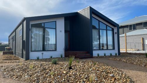 a black and white house with glass windows at 32 Plateau in Metung
