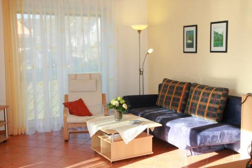 a living room with a couch and a table at Ferienwohnungen Holder in Anhausen
