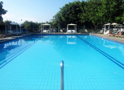 a large swimming pool with blue tiles on it at Marina Hotel in Ayia Napa