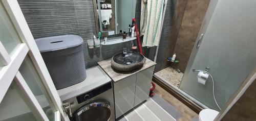 a small bathroom with a sink and a washing machine at Марказ_5 in Tashkent