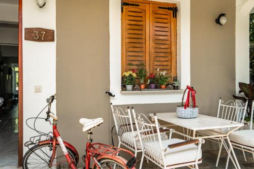 a bike parked next to a table and a window at Makis Family Studio in Katelios