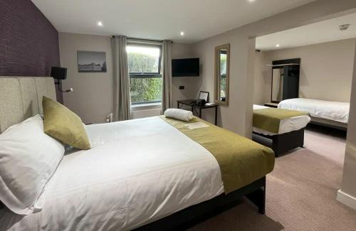 um quarto de hotel com uma cama grande e uma janela em Lydiard Park Hotel & Conference Centre em Swindon