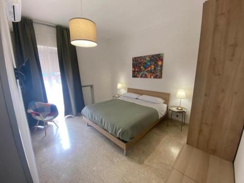 een slaapkamer met een bed, een tafel en een stoel bij affittacamere San Michele in Taranto