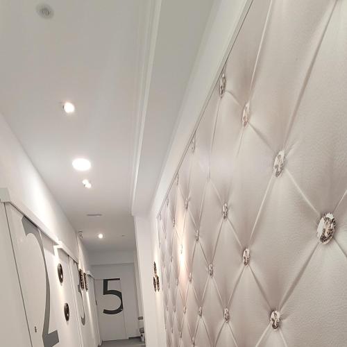 a hallway with white walls and a number on the wall at ALBERGUE de Caldas de Reis URRACA in Caldas de Reis