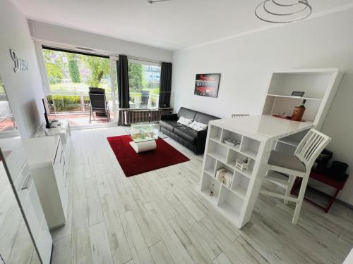 a living room with a white desk and a couch at Bellevue Nr. 15 in Scharbeutz