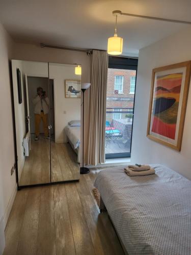 a bedroom with a bed and a person taking a picture at WALKING TO TOWER BRIDGE in London