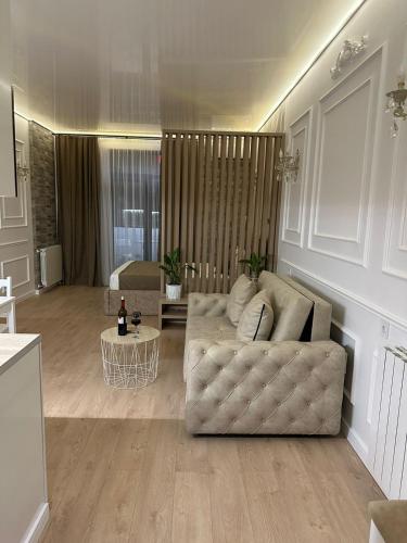 a living room with a couch and a table at Moonlight Apart-Hotel Batumi in Batumi