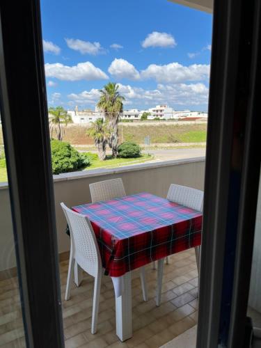 a table and chairs on a balcony with a view at Le Stanze di Lucia vicino Ospedale Cardinale Panico a Tricase in Tricase
