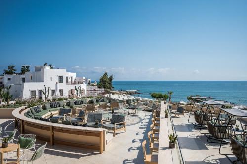 a view of a resort with chairs and the ocean at Creta Maris Resort in Hersonissos