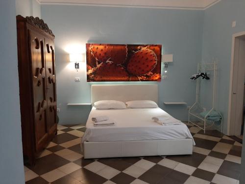 una camera da letto con un letto e un dipinto sul muro di Dimora " Le Rose " a Lecce