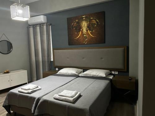a bedroom with a bed with two towels on it at Deluxe Center Apartment - Preveza in Preveza